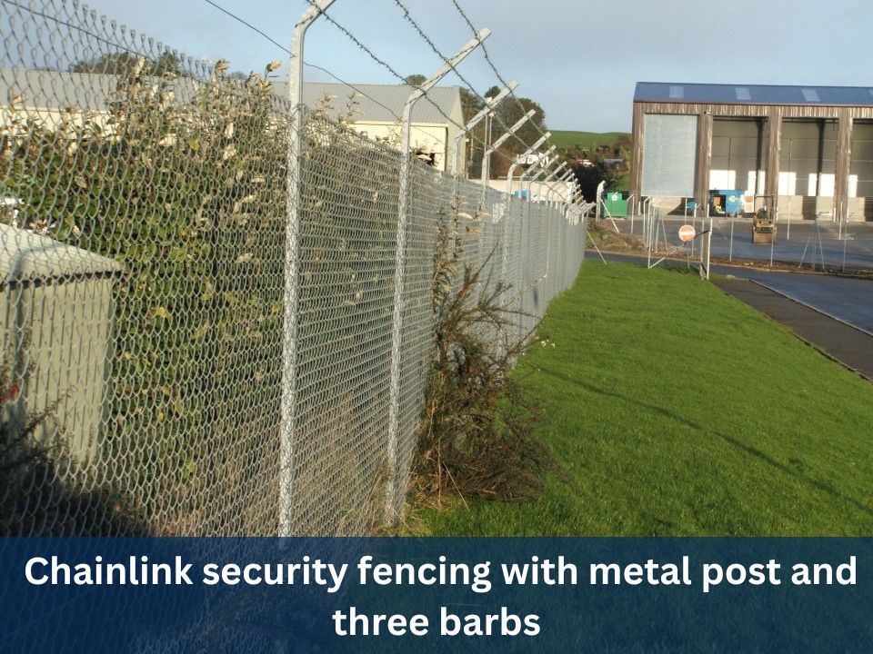 Chainlink security fencing with metal posts and three barbs