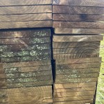 Stack of 4.8m by 8" wooden fence rails