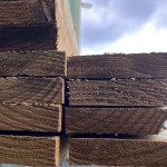 Stack of 4" x 1" wooden fence rails