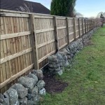 Wooden drail fencing rail shown on a fence