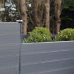 DuraPost composite gravel boards stacked on a fence