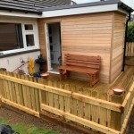Our decking boards are machined out of Swedish Redwood, shown here with timber decking surrounded by a picket fence.