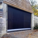 Galebreaker Agridoor Classic door shown in black on a shed