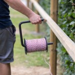 Rutland on hand roll aid shown being used on a fence