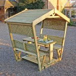 Zest Stirling Arbour covered garden seating shown in a garden setting