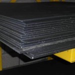 Stockboard or stokbord, stacked in a pile sitting on metal shelves