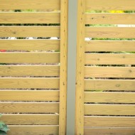 DuraPost Olive Grey shown with wooden fence panels