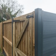 DuraPost gate/corner posts shown with a wooden gate hanging on them