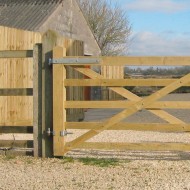 Wooden gate hinge kit attached to gate
