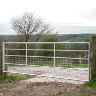 Half mesh galvanised gate shown in an agricultural setting