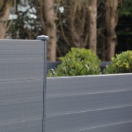 A DuraPost post cap with bracket shown on a DuraPost fence