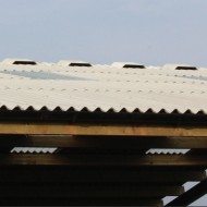 Briarwood close fitting ridge sheets shown on a fibre cement shed roof