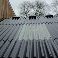 Slate Blue painted fibre cement sheets shown on a shed roof