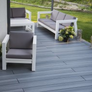 Newtechwood Ultrashield silver grey solid composite deck boards shown in a garden setting
