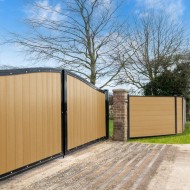 DuraPost Vista Cedar composite fencing panels shown with a driveway gate