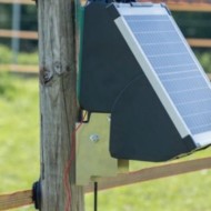 Wooden post mount shown attached to a post with an energiser connected
