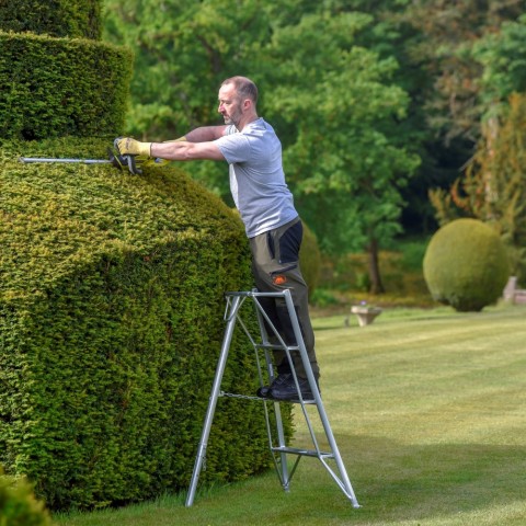 4ft Hendon Tripod Ladder shown being use cut a hedge