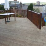 Our decking boards are machined out of Swedish Redwood Timber, shown here in a garden setting with railing.